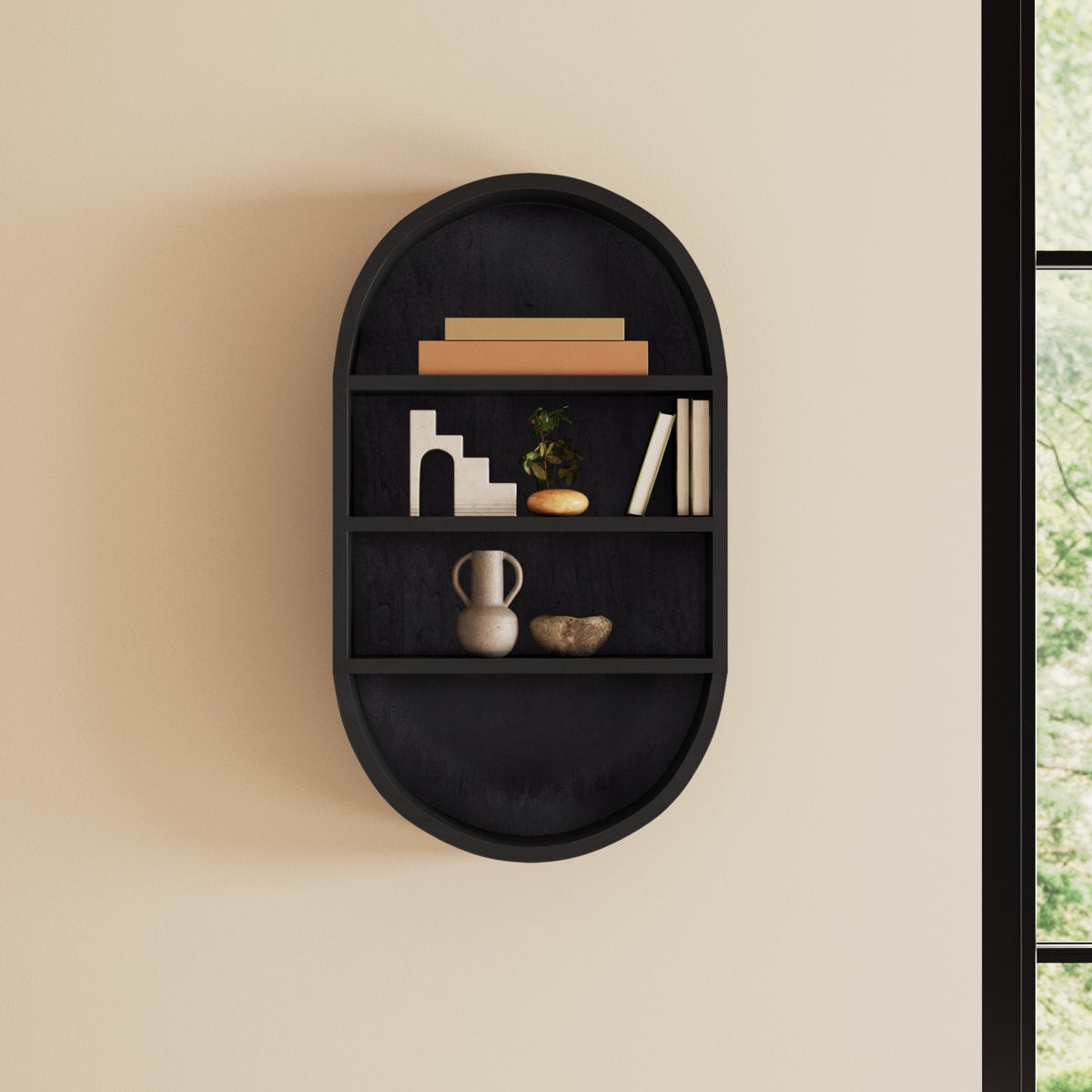 Black wall shelf with decorative items against a beige wall