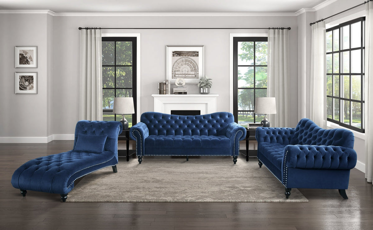 Blue velvet sofa set in a living room with large windows and a fireplace.