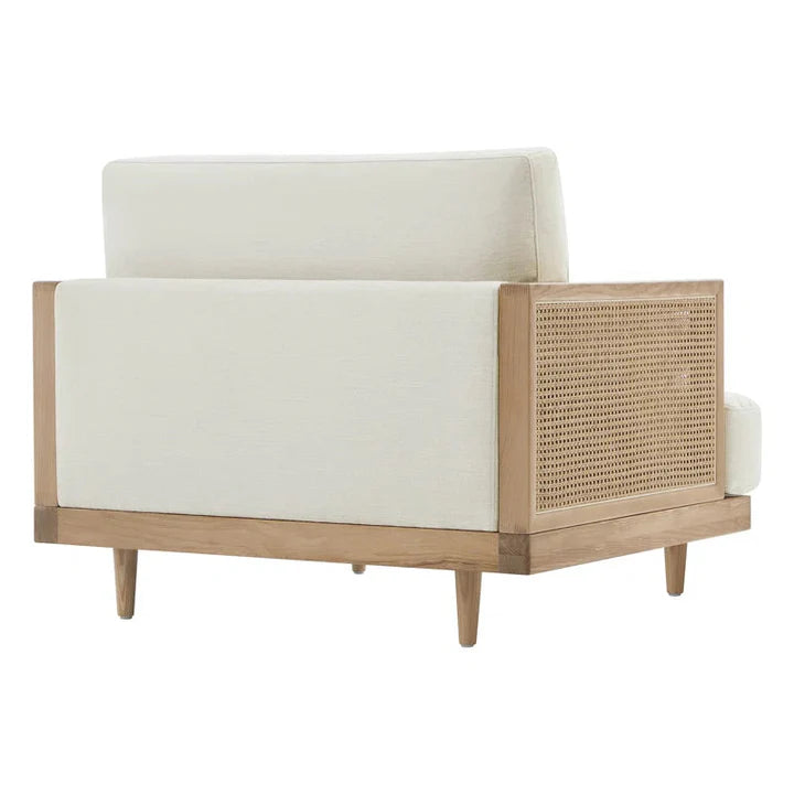Chair with white cushion and wicker frame on a white background