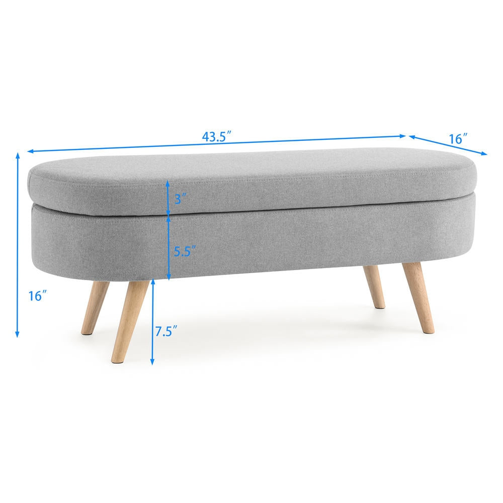 Gray upholstered bench with wooden legs and dimensions marked on a white background