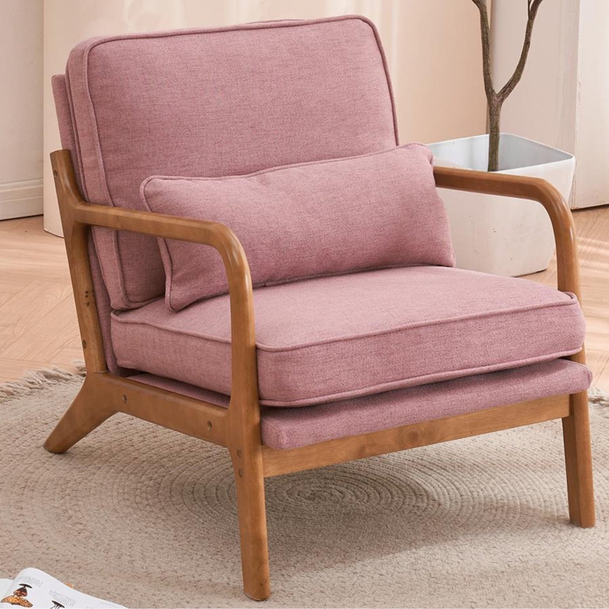 Pink armchair with wooden frame on a beige carpet