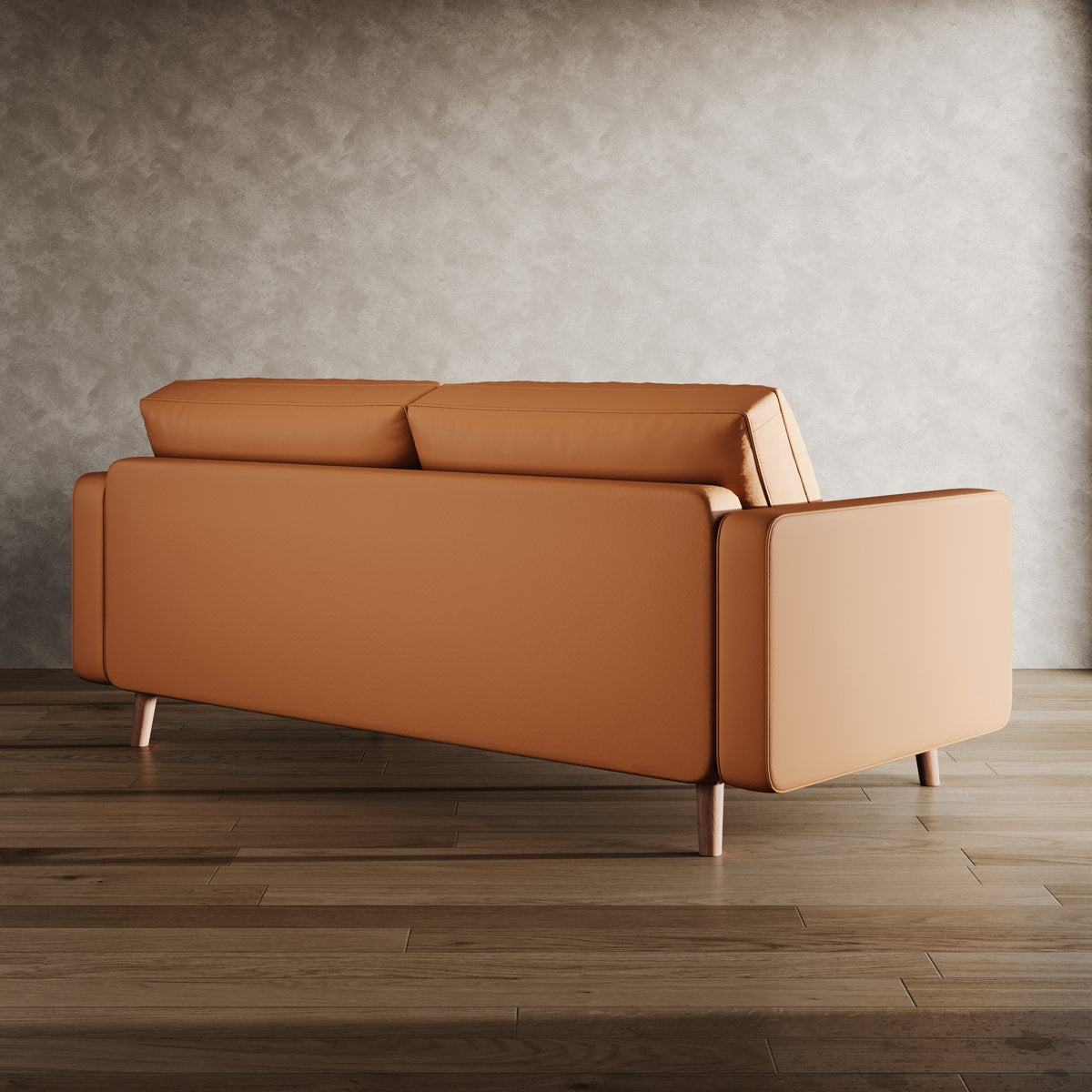 Brown leather sofa on a wooden floor with a gray wall background