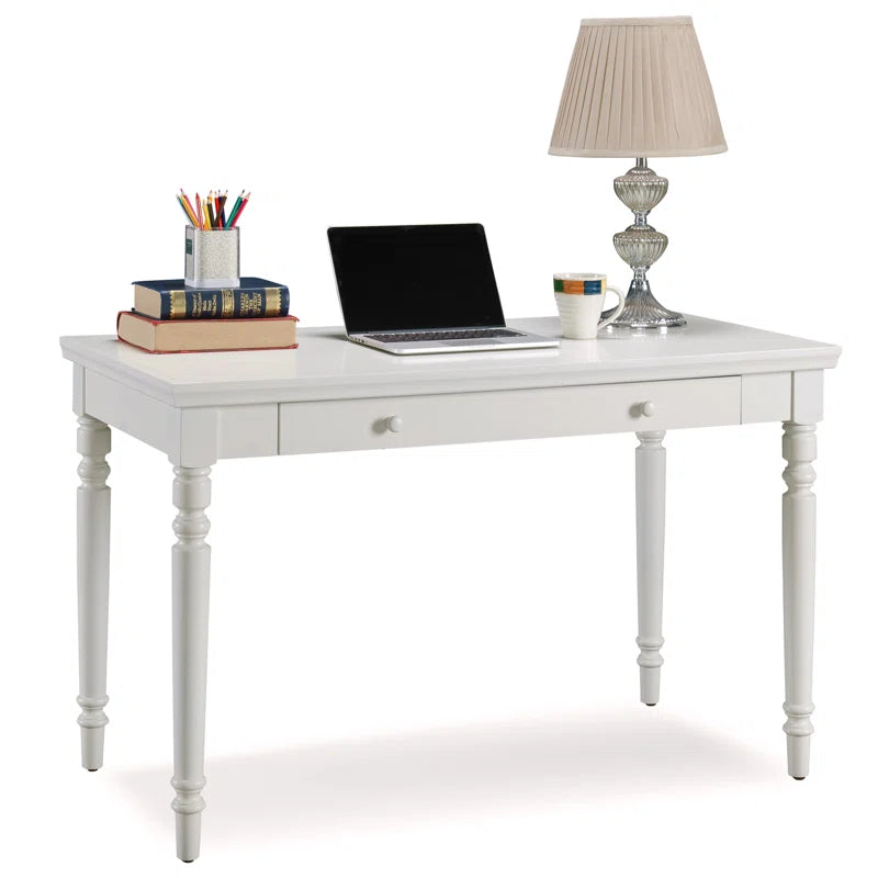 White desk with laptop, books, and lamp on a white background