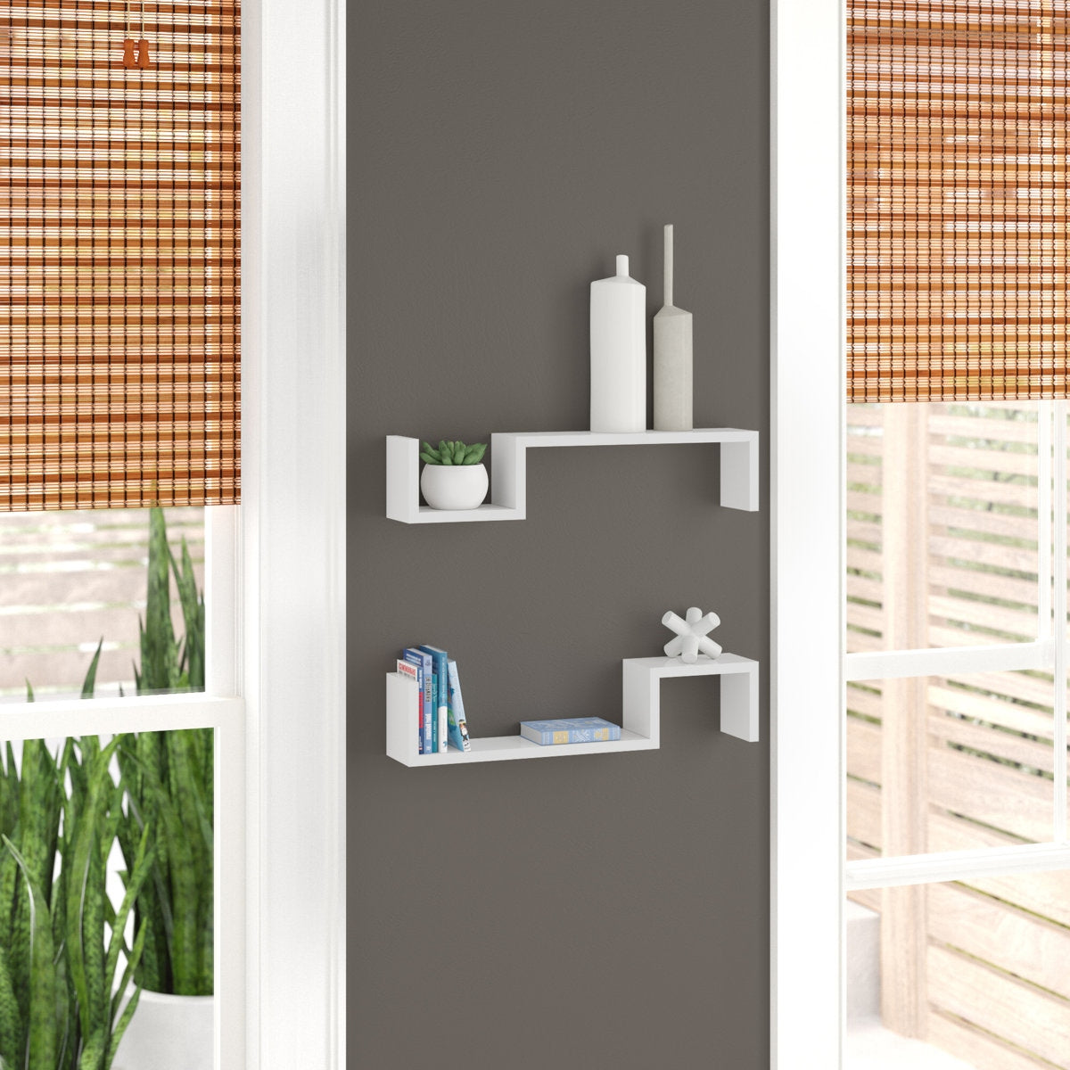 White wall shelves against a gray wall with decorative items.