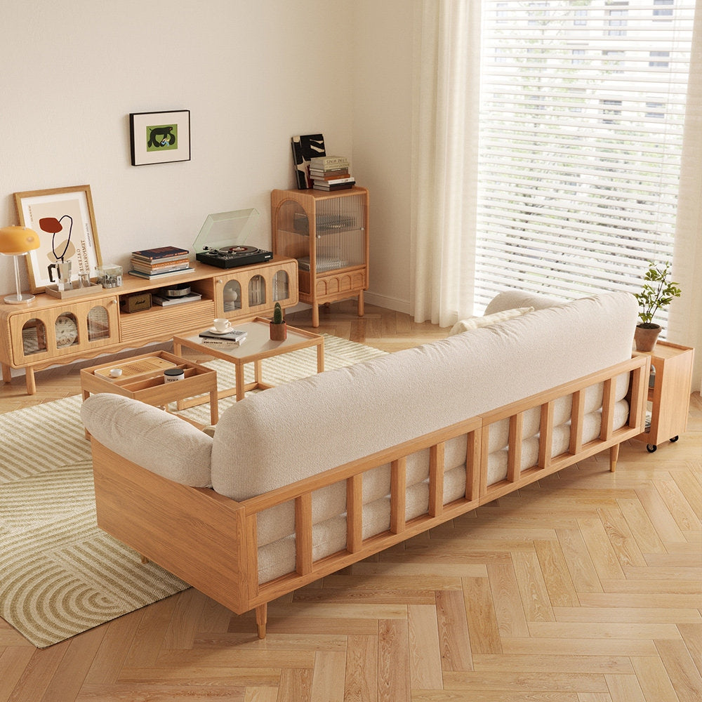 Wooden sofa in a living room with wooden furniture and decor.