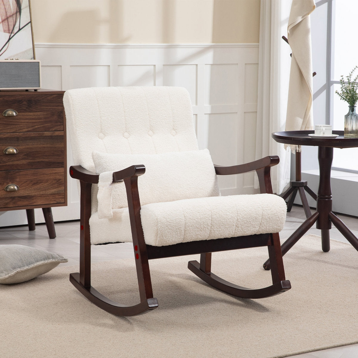 White rocking chair with wooden frame in a room setting