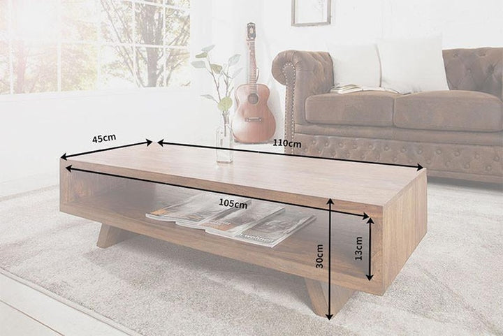 Wooden coffee table with dimensions marked in a living room setting