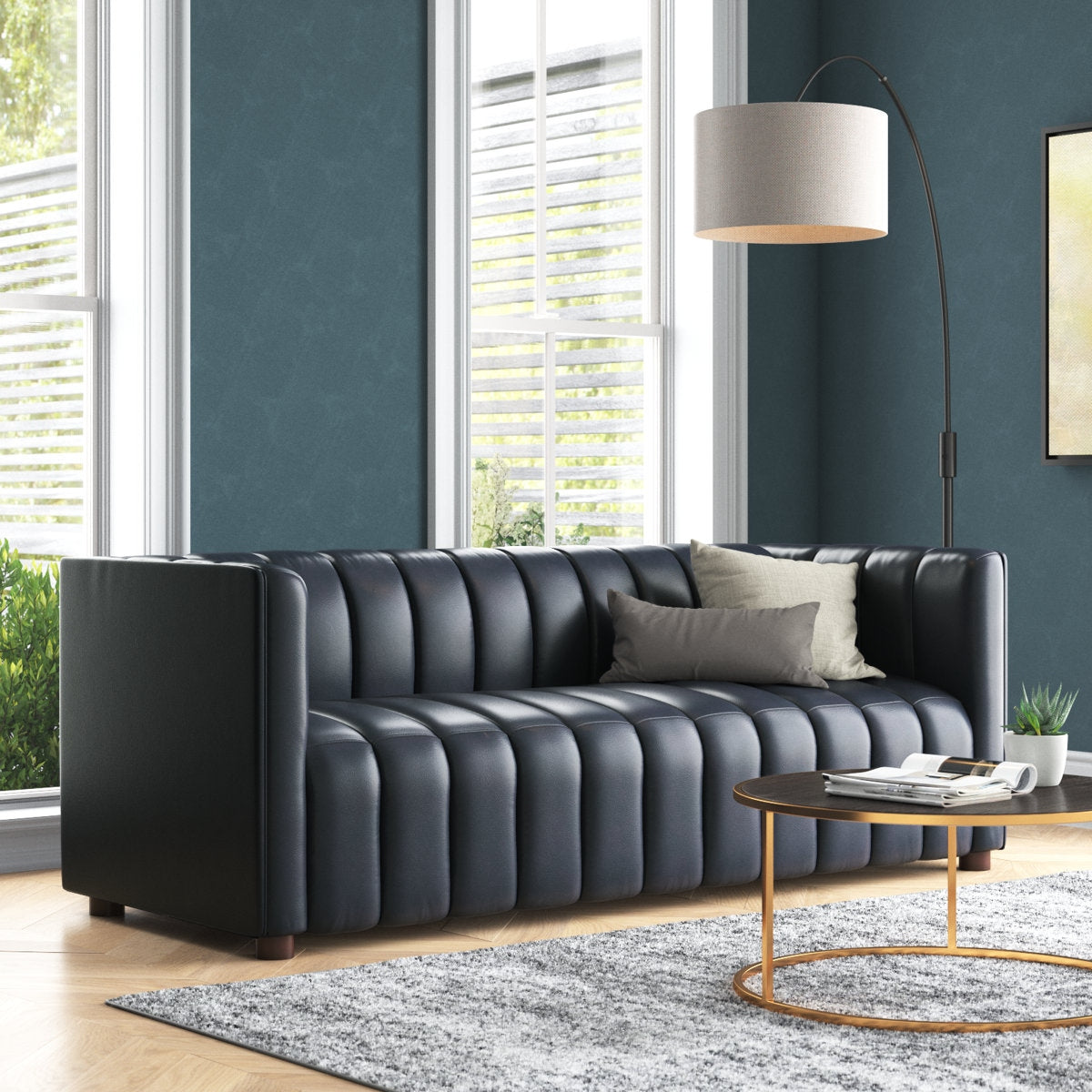 Modern living room with a black leather sofa, coffee table, and decorative elements.