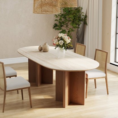 Dining room with a wooden table and chairs, decorated with flowers and decor items.