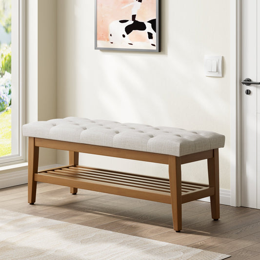 Wooden bench with white cushion in a room with a painting on the wall.