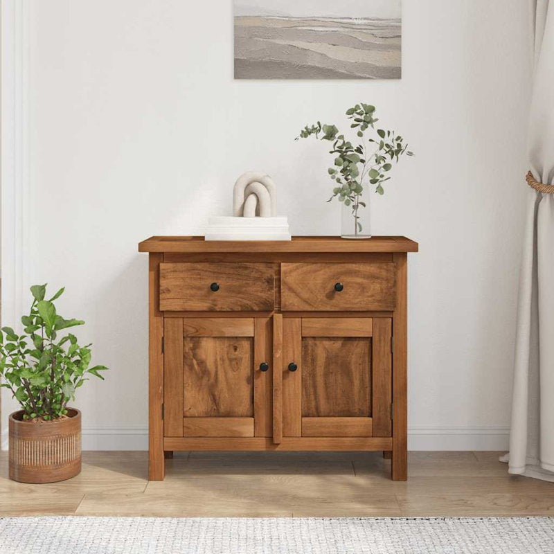 Wooden cabinet with two doors and two drawers in a room with plants and a painting.