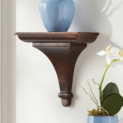 Wooden wall shelf with a blue vase and white orchid against a white wall