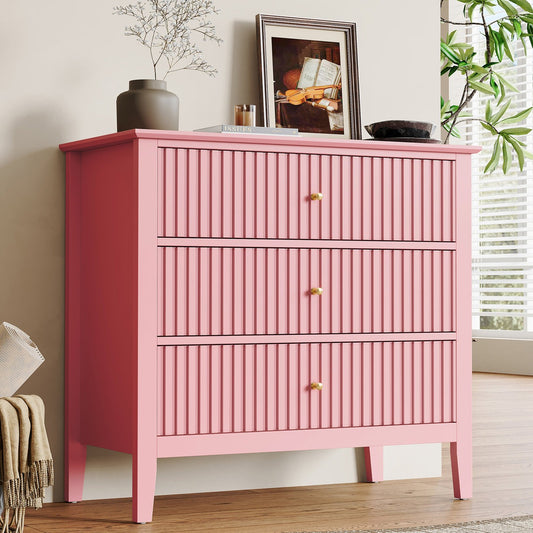 Pink dresser with three drawers in a room setting