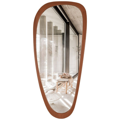 Wooden-framed mirror reflecting a room with furniture and decor.