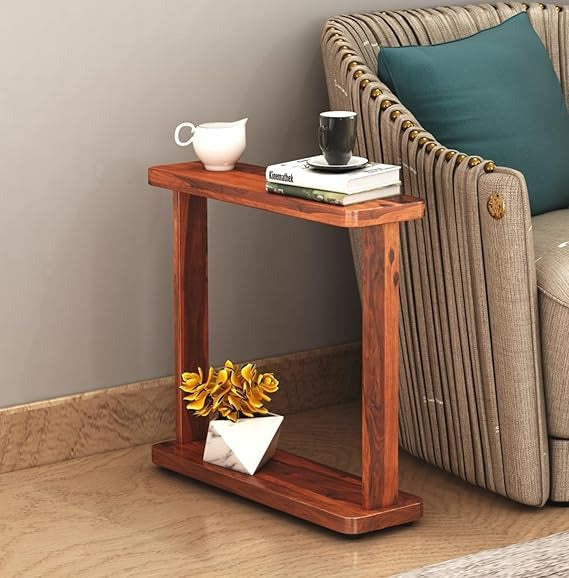 Wooden side table with decorative items next to a sofa