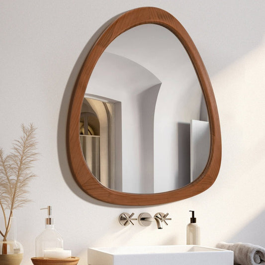 Bathroom vanity with wooden-framed mirror, sink, and decorative elements.