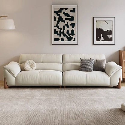 Beige sofa in a living room with abstract art on the wall
