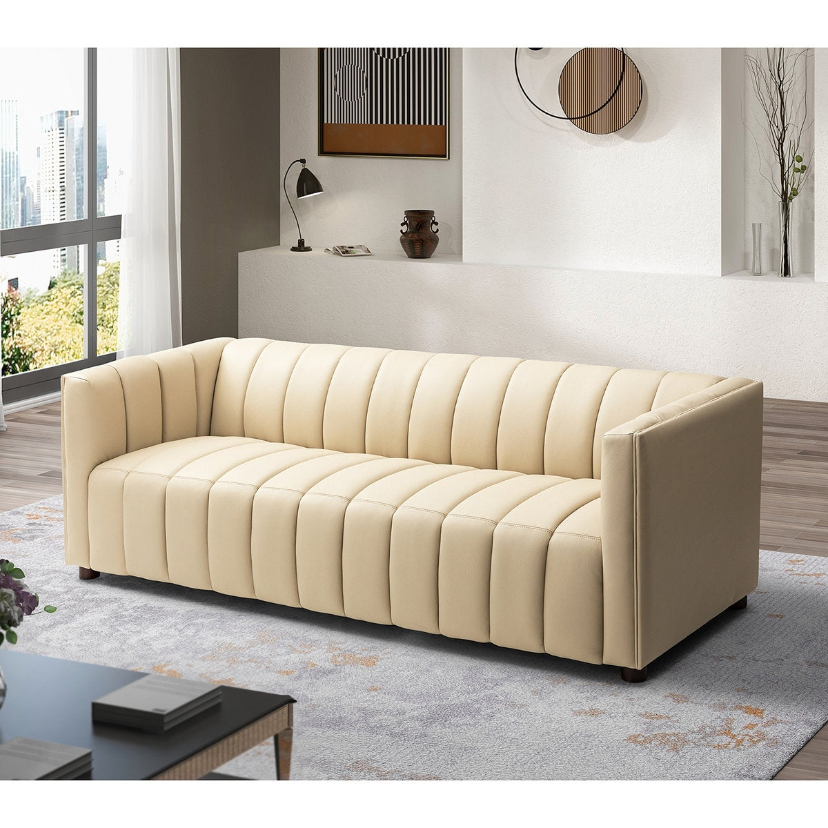 Beige sofa in a modern living room with large windows and decorative elements.