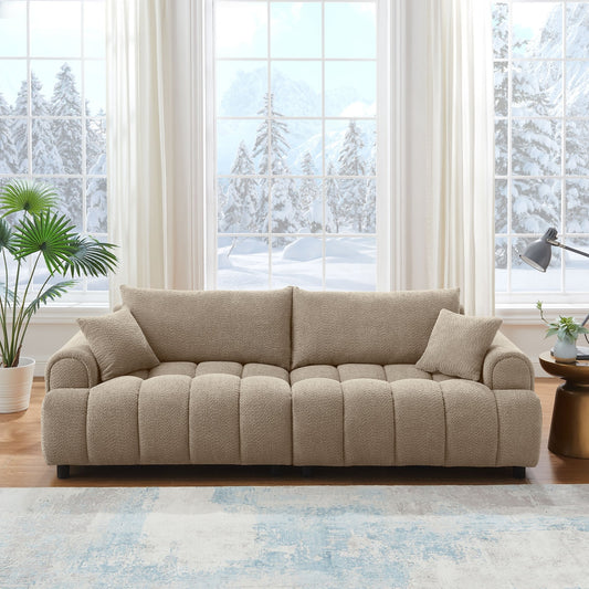 Beige sofa in a living room with large windows showing a snowy outdoor view.