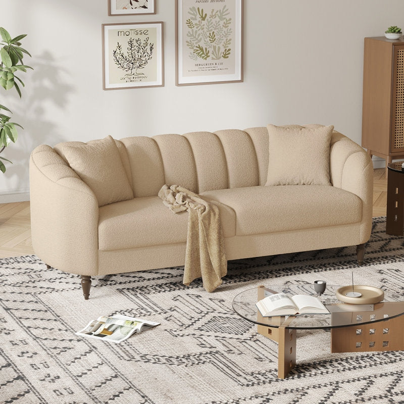 Beige sofa in a living room with a coffee table and decorative elements.