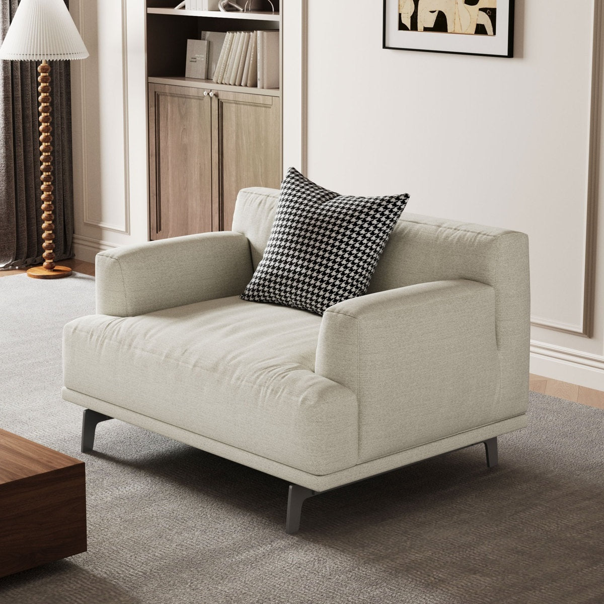 Beige sofa with a black and white patterned pillow in a living room setting.