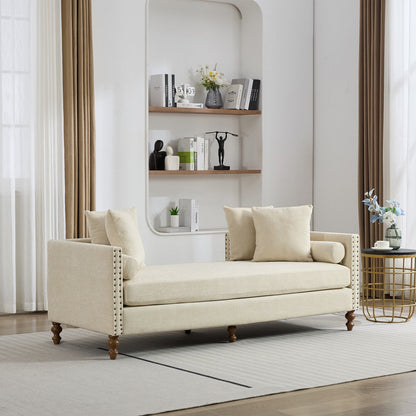Beige sofa in a living room with a shelf and decor items.