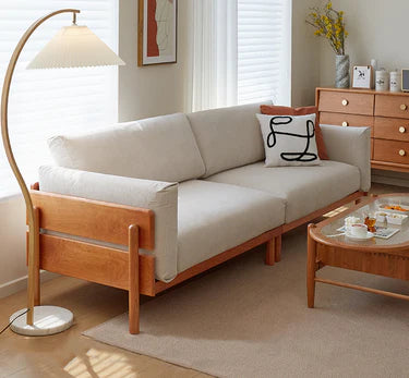 Beige sofa with wooden frame in a living room setting