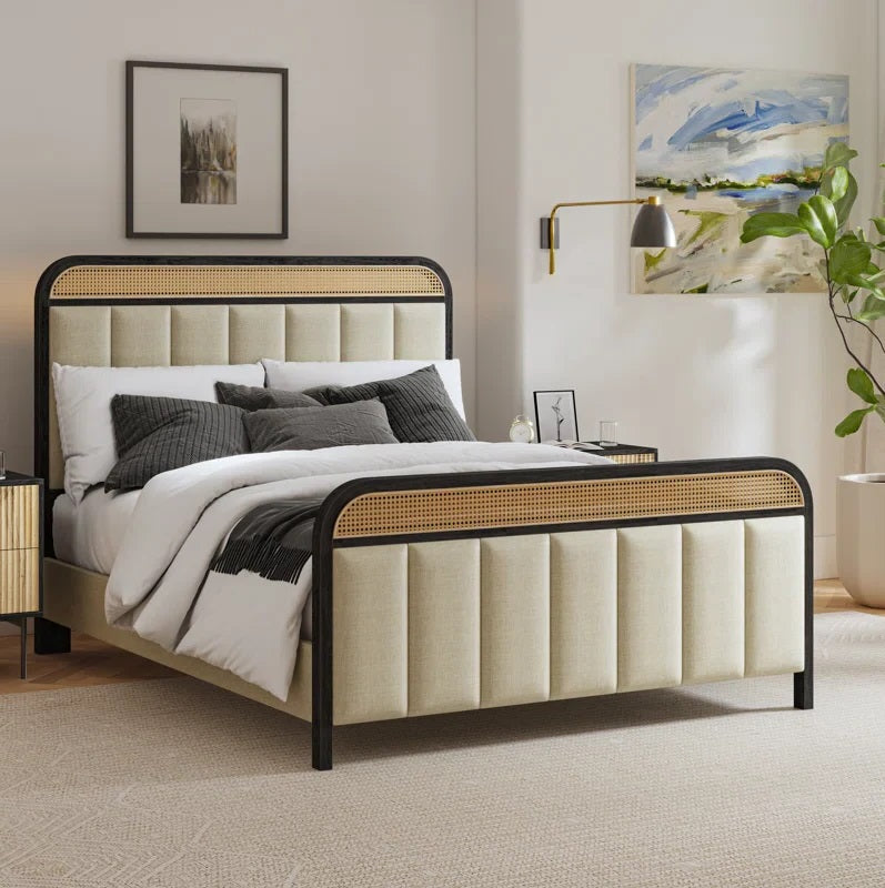 Beige upholstered bed with black metal frame in a bedroom setting