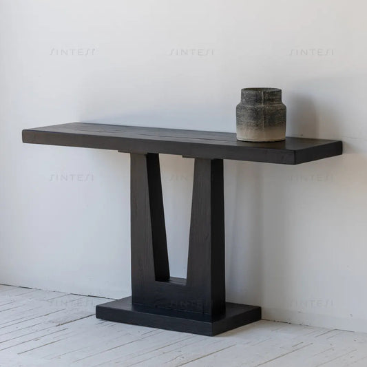 Black console table with a vase on a white background