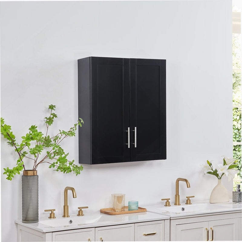 Black wall-mounted cabinet above a sink with brass fixtures in a modern kitchen.