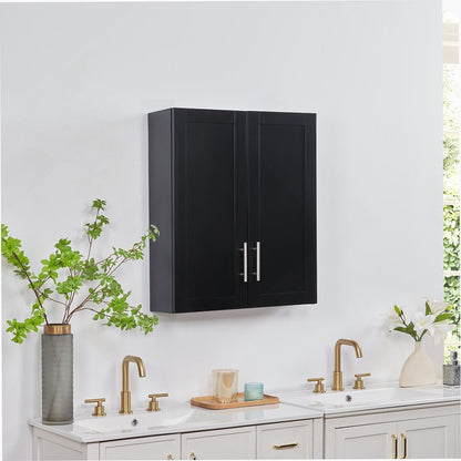 Black wall-mounted cabinet above a sink with brass fixtures in a modern kitchen.