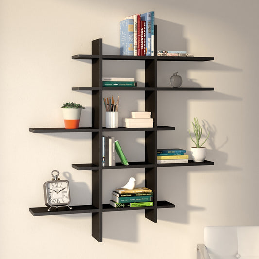 Black wall shelf with books, plants, and decorative items against a beige wall.