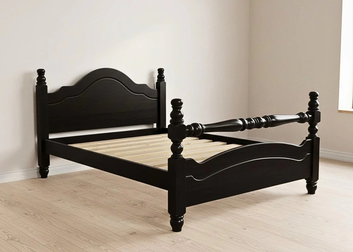 Black wooden bed frame in a room with light wood flooring and white walls.