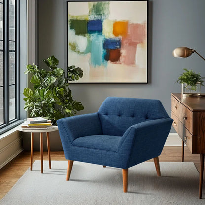 Blue armchair in a living room with abstract art and plants