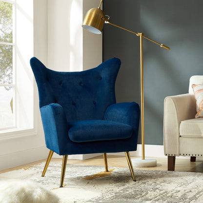 Blue armchair with gold legs in a living room setting
