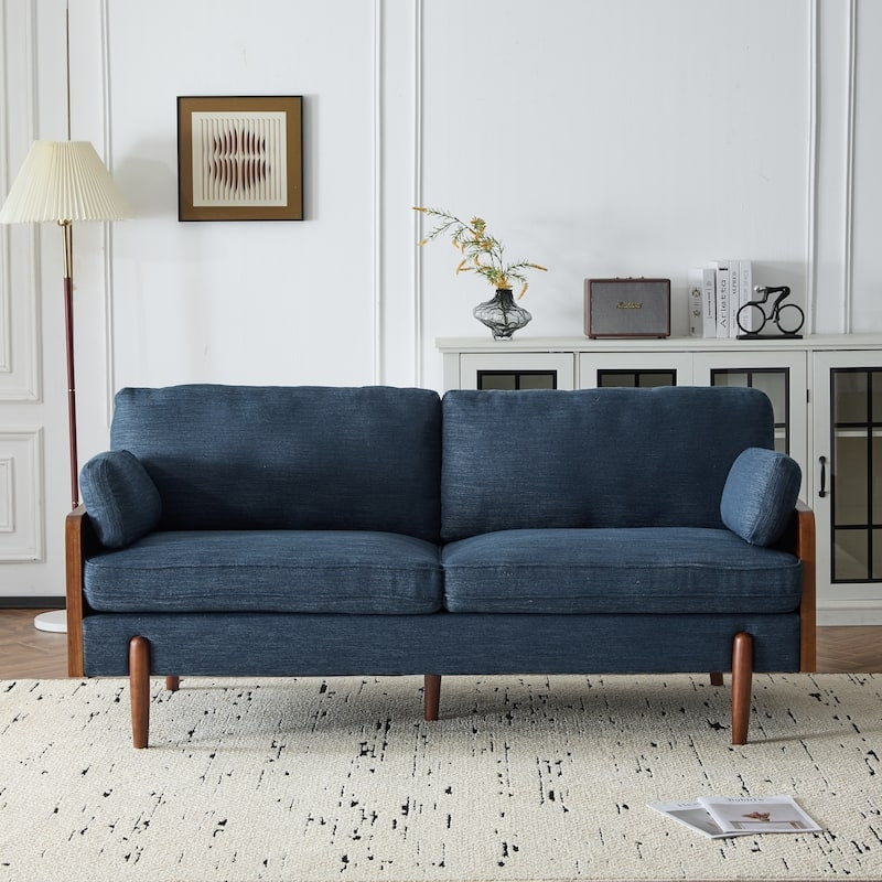 Blue sofa in a living room setting with a lamp and decorative items.