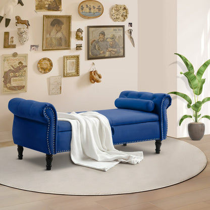 Blue upholstered bench with a white blanket in a room with decorative wall art and a plant.