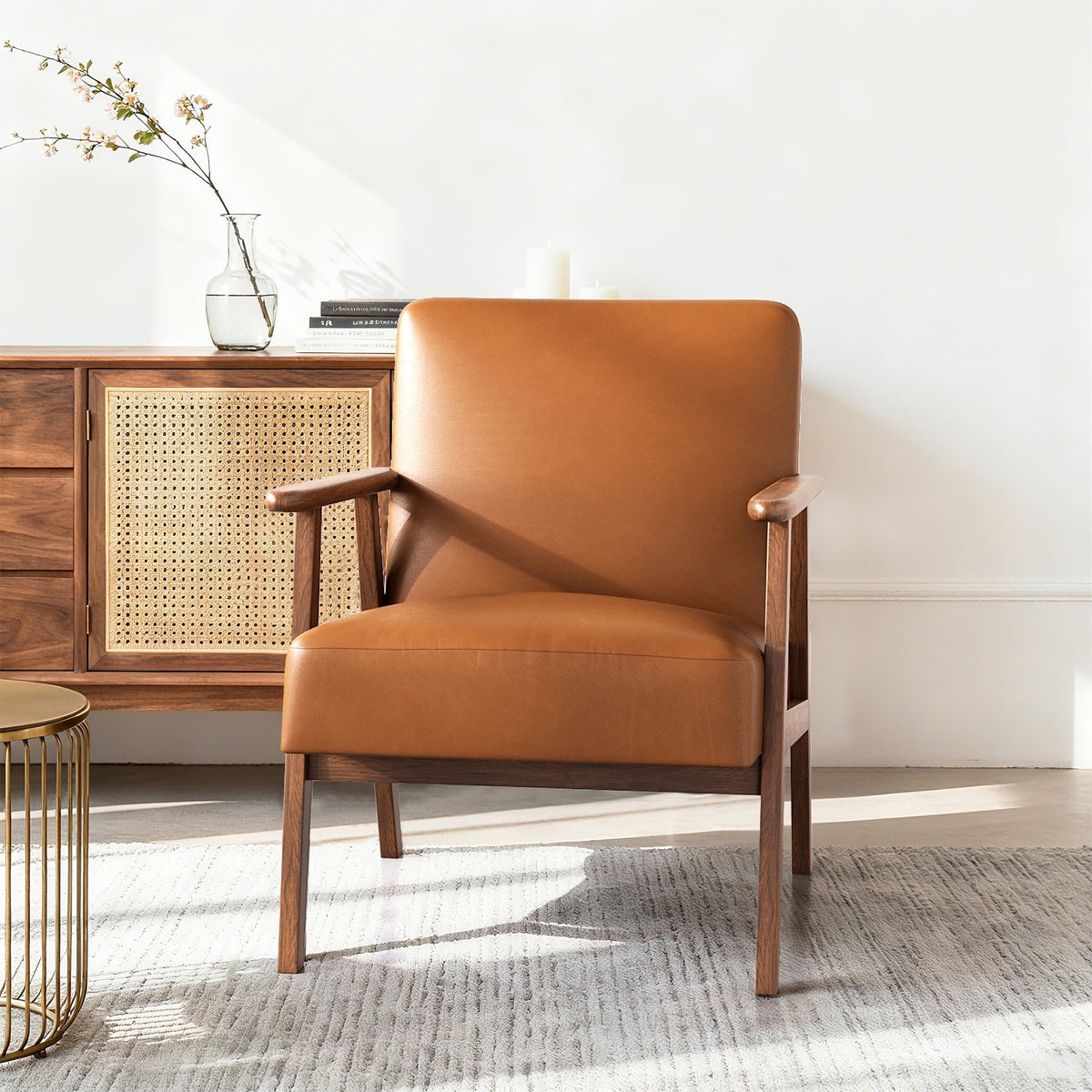 Brown leather armchair in a room with wooden furniture and a vase.