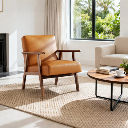 Brown leather armchair in a living room with a coffee table and books.