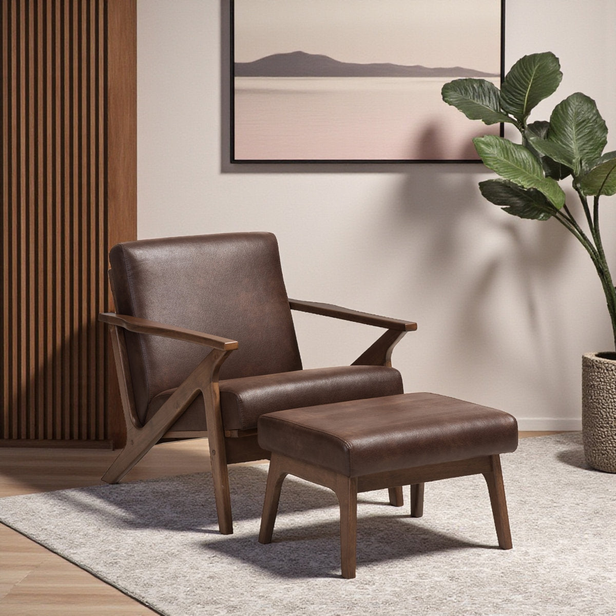Brown leather armchair with ottoman in a room with a painting and plant