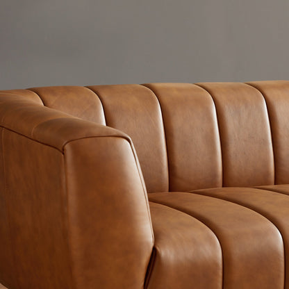 Brown leather sofa against a gray wall