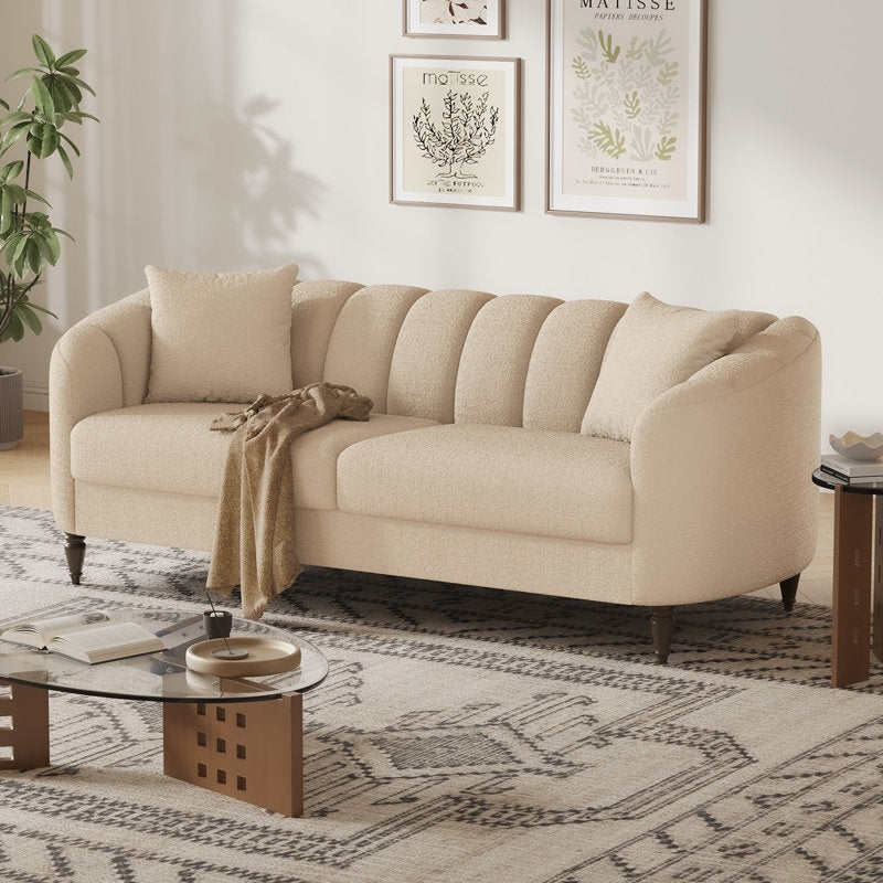 Beige sofa in a living room with a coffee table and decorative elements.