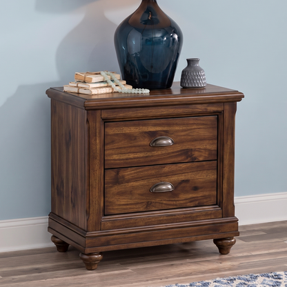 Wooden nightstand with two drawers against a light blue wall.