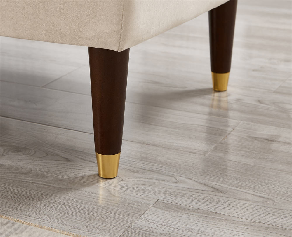 Chair legs with gold tips on a wooden floor