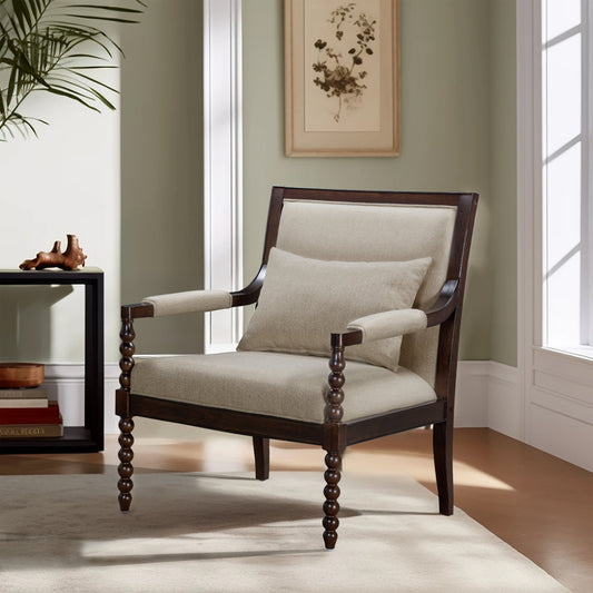Chair with wooden frame and beige cushion in a room with a plant and framed picture on the wall.