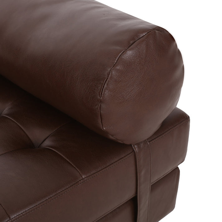 Close-up of a brown leather armchair on a white background