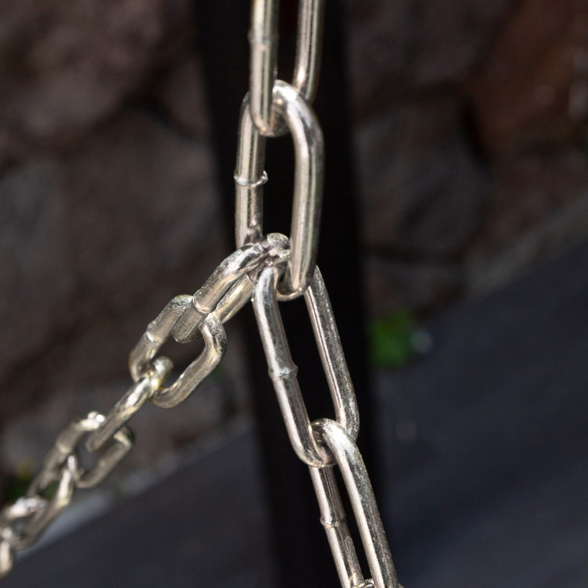 Close-up of a metal chain with a blurred background
