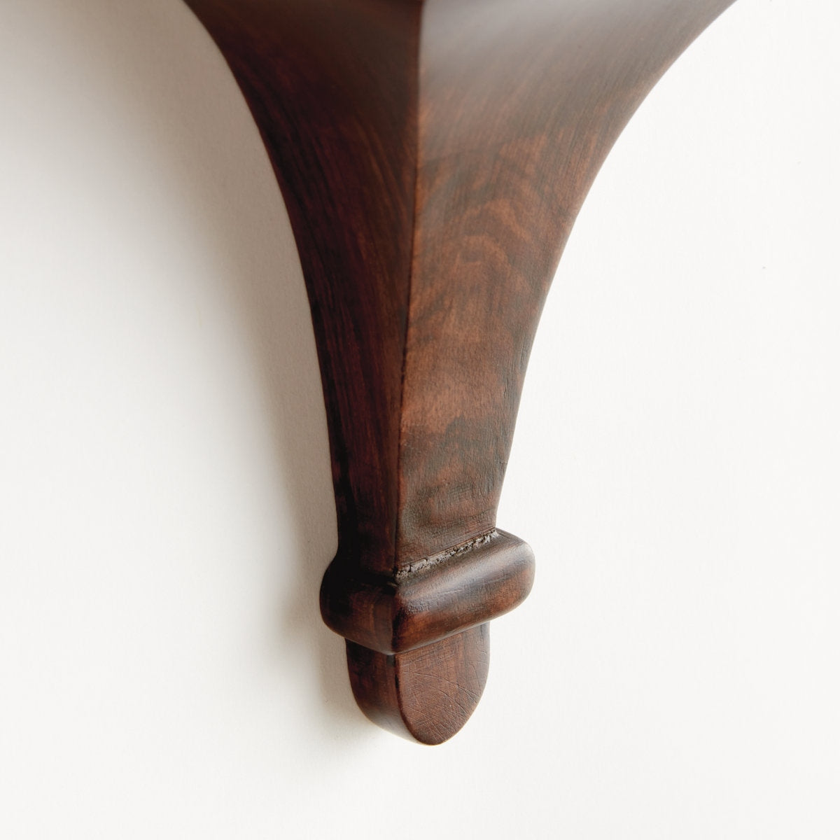Close-up of a wooden bracket on a white background