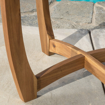 Close-up of a wooden chair frame on a stone patio