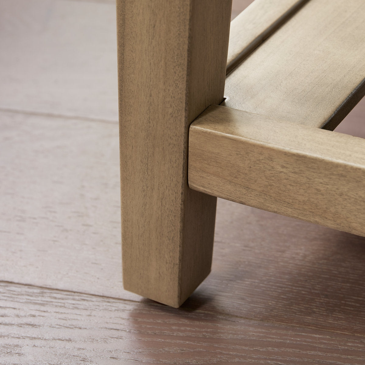 Close-up of a wooden chair leg on a wooden floor